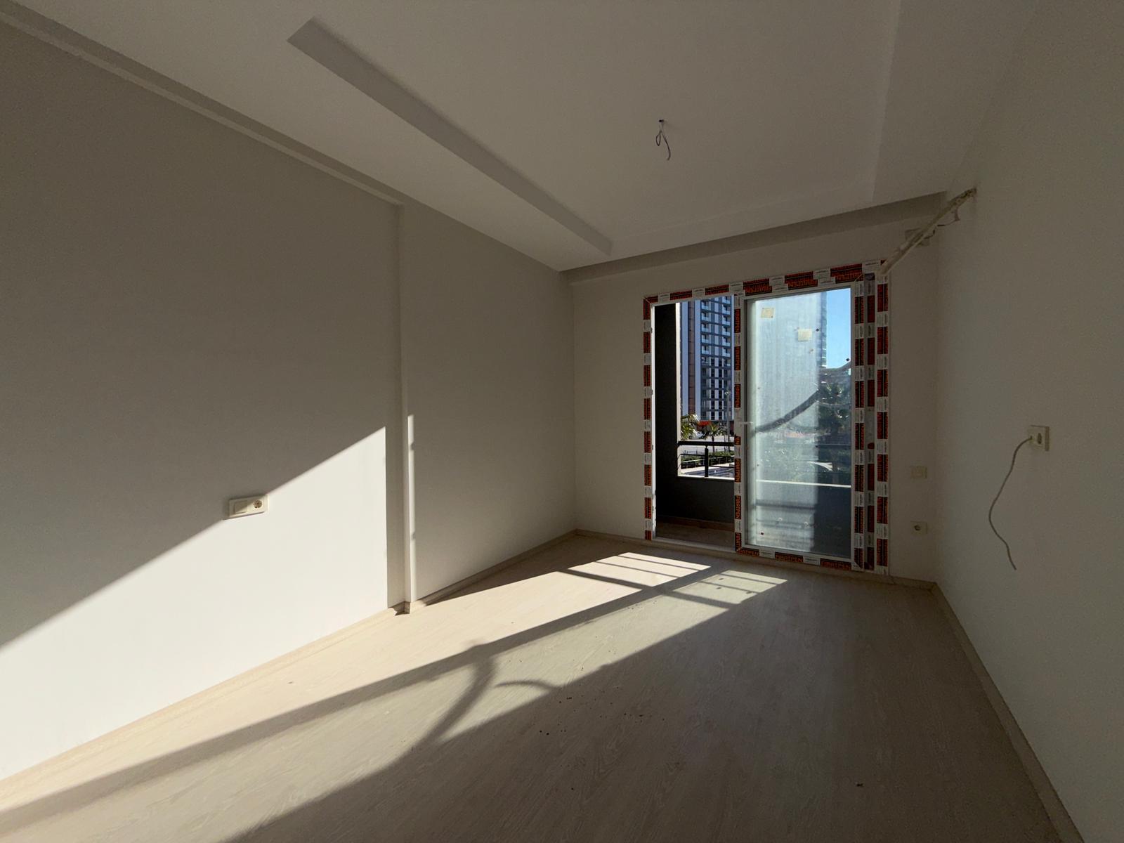 Moderne 1+1 lejlighed til salg i Mersin Tomuk nær havet