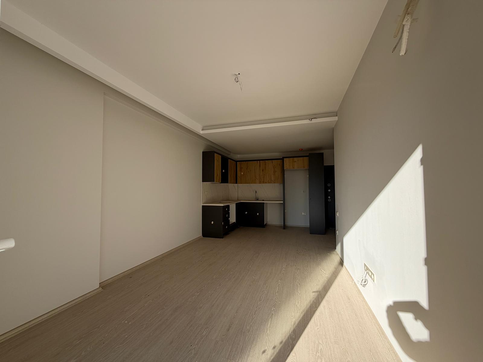 Moderne 1+1 lejlighed til salg i Mersin Tomuk nær havet