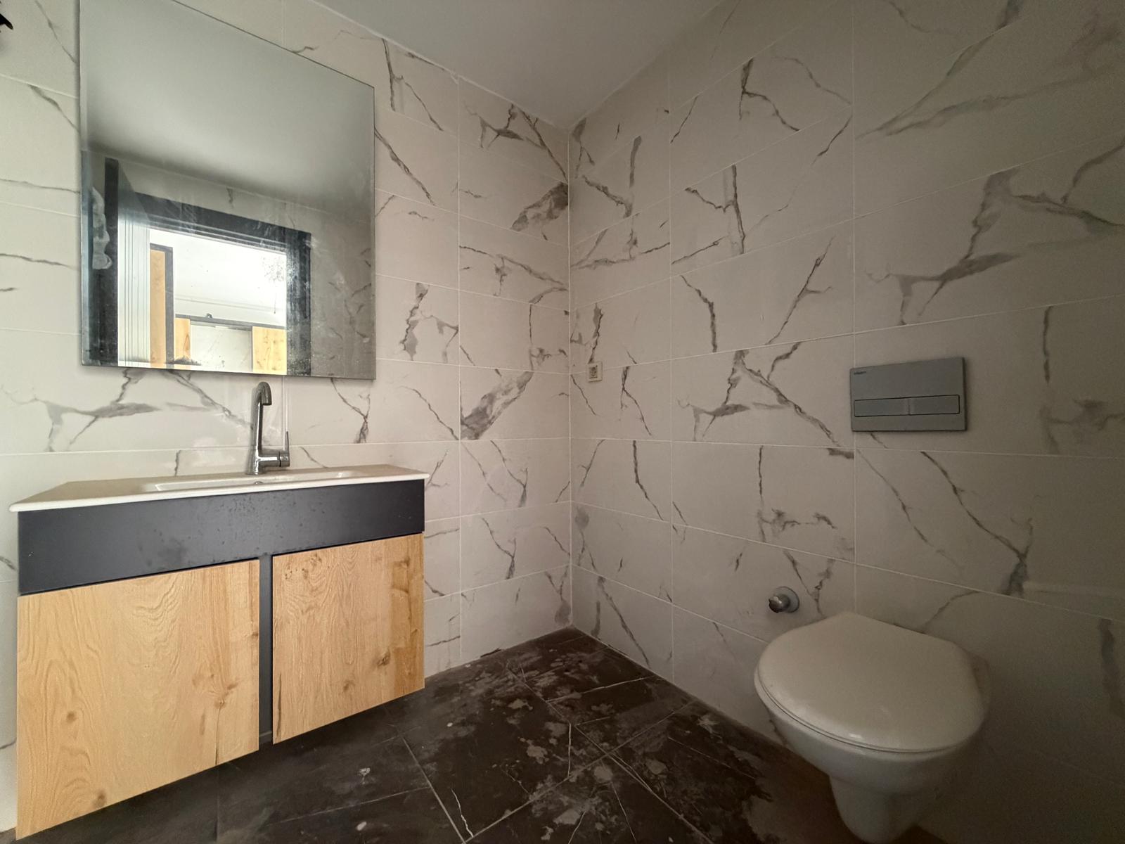 Moderne 1+1 lejlighed til salg i Mersin Tomuk nær havet